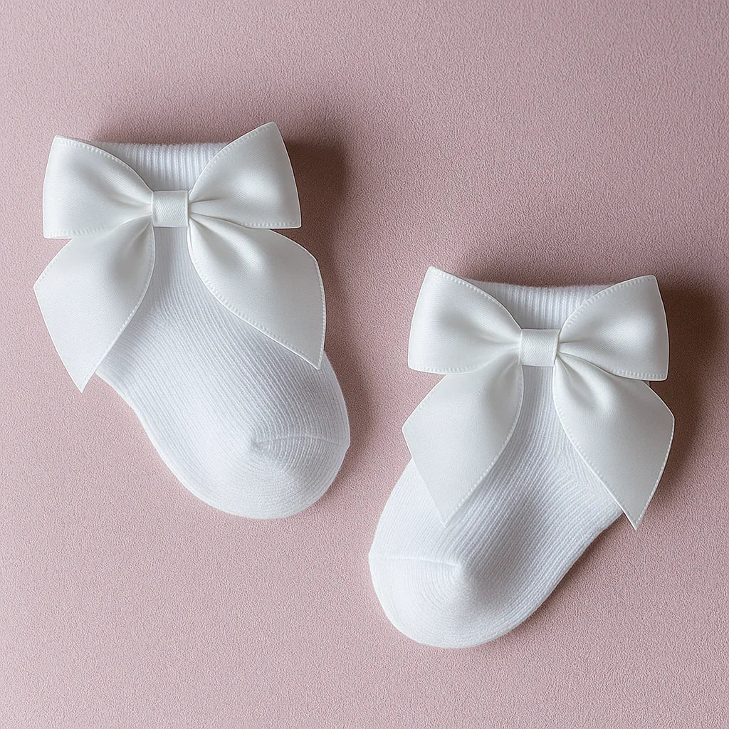 White socks with large bows on a pink background