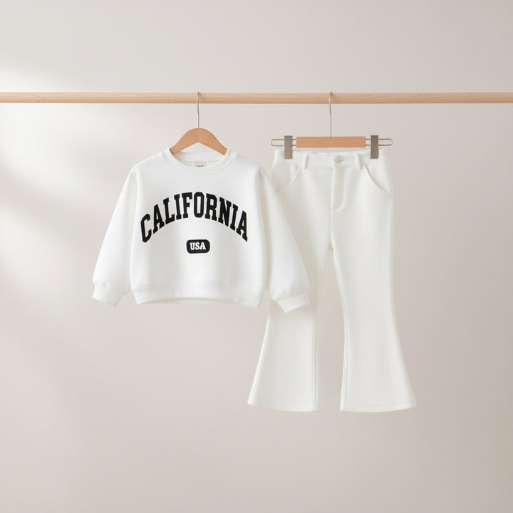 White sweatshirt with 'California USA' text and white pants on a wooden hanger against a light gray background.