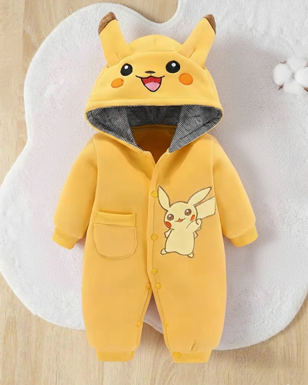 Yellow baby romper with Pikachu design on a white background