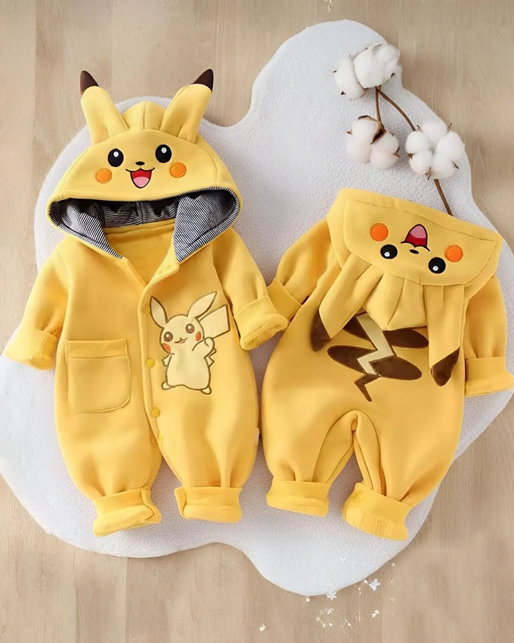 Two yellow baby onesies with cartoon designs on a light brown background
