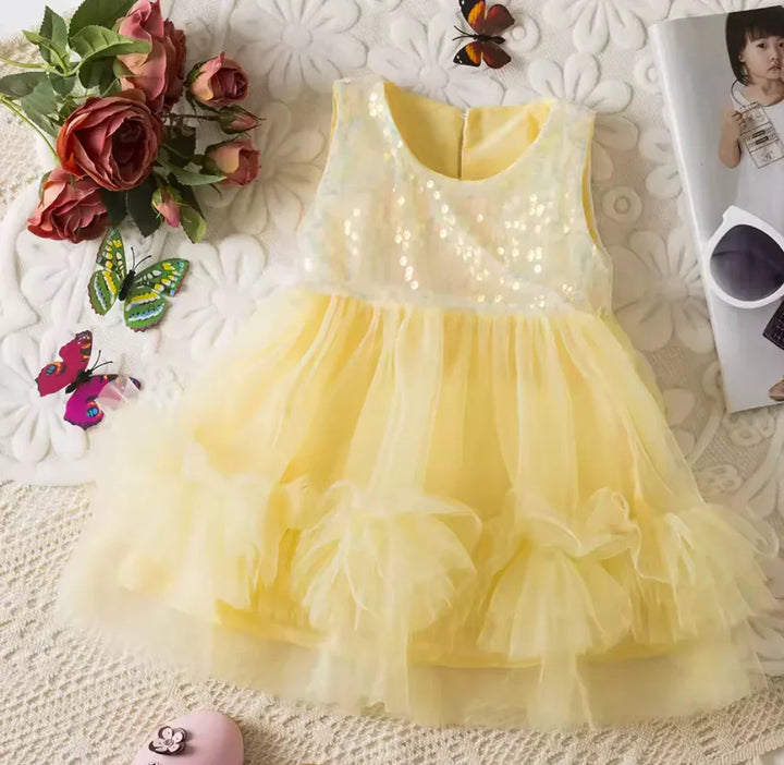 Yellow dress with LED lights on a textured surface with flowers and butterflies.