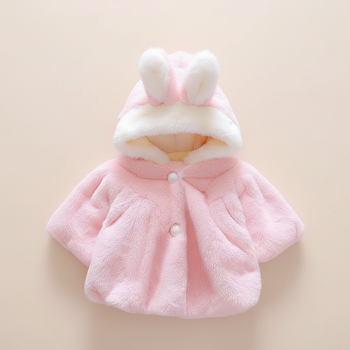 Pink baby coat with white fur hood on a beige background