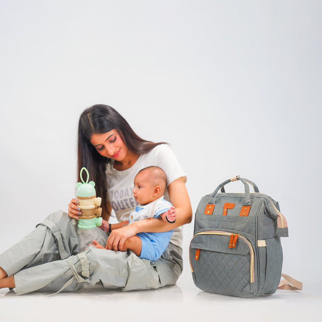 mom with baby and feed with grey maternity bag