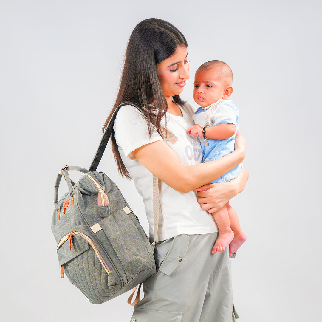mom and baby with grey maternity bag