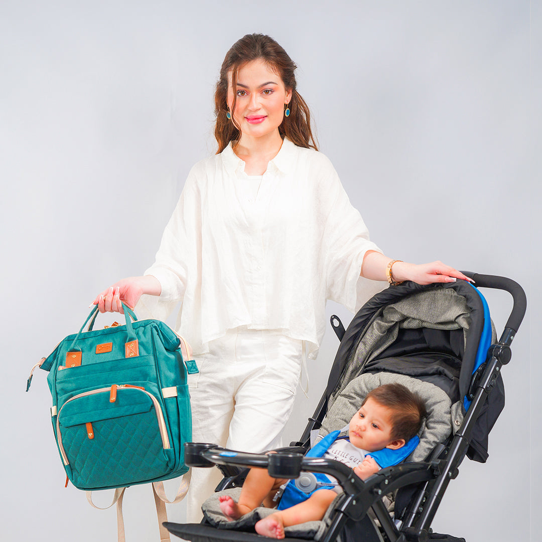 Mom with cyan maternity bag and baby in the stroller
