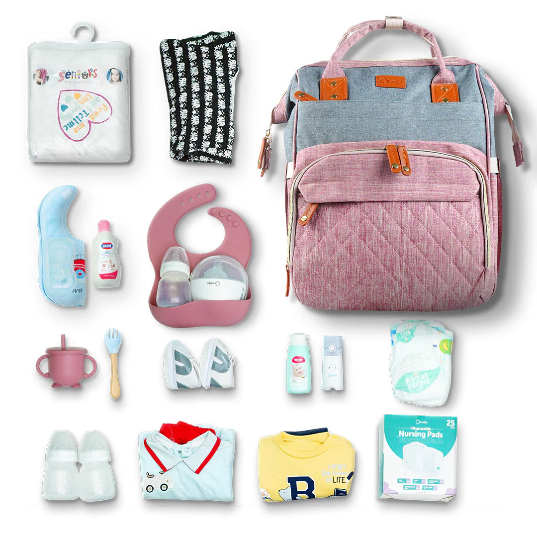 Collection of baby care items including a pink backpack, diapers, bottles, and toys on a white background.