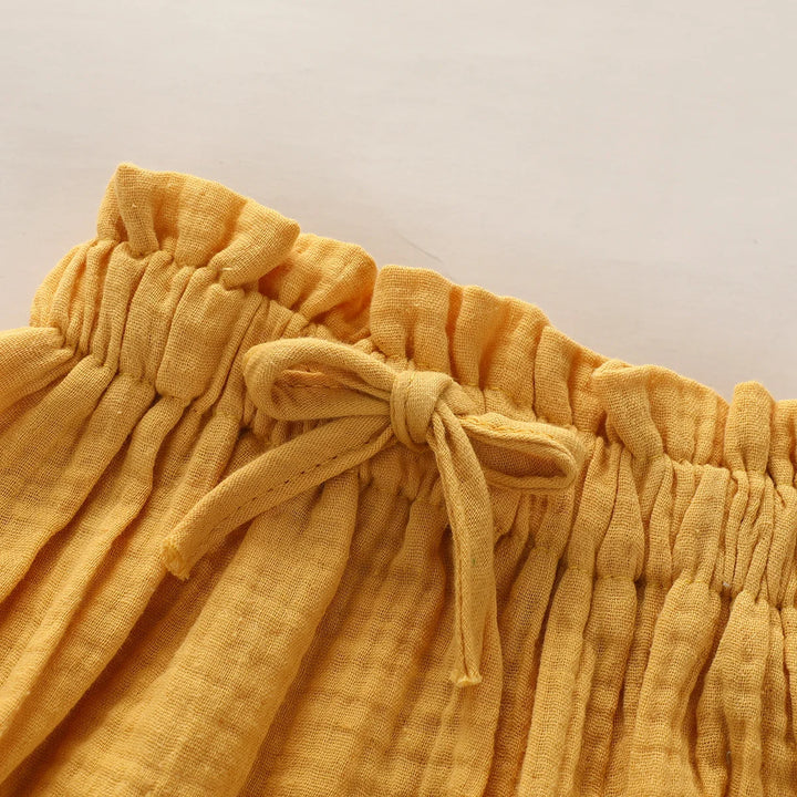 Yellow fabric with a tie detail on a light gray background