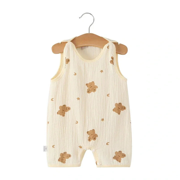 Baby romper with bear pattern on a wooden hanger against a white background