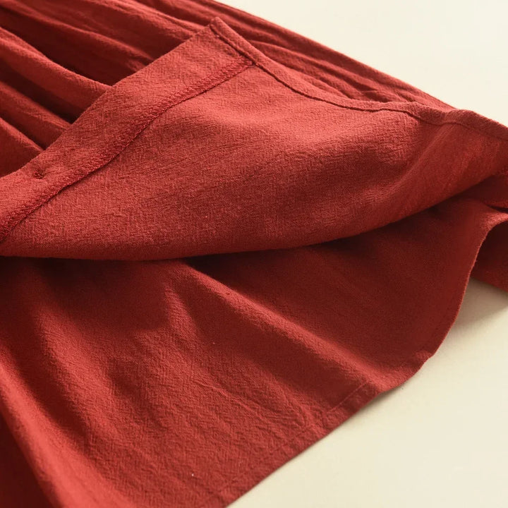 Close-up of a red fabric texture on a beige background