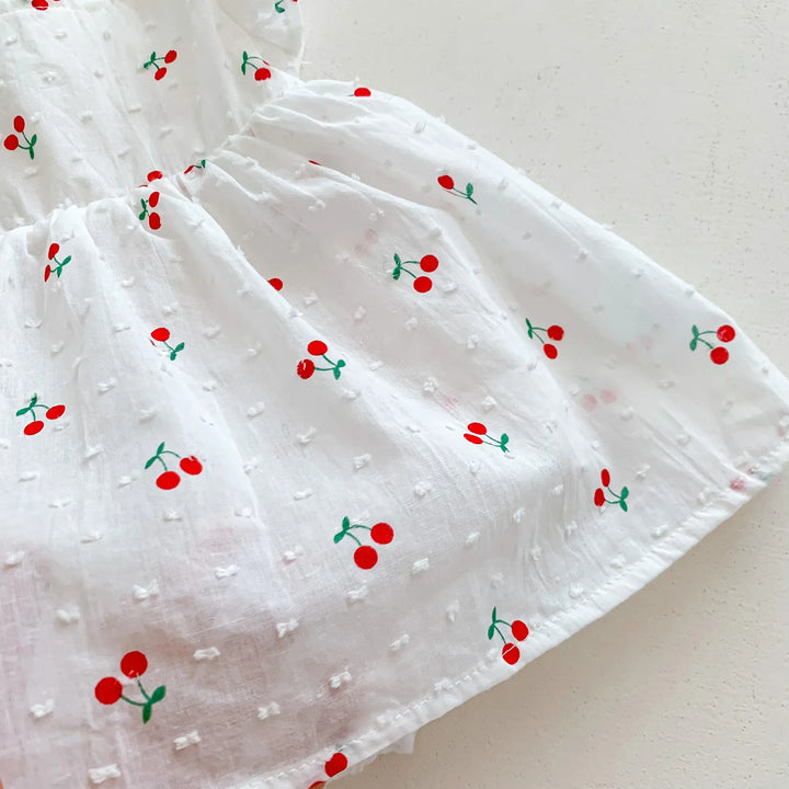 White fabric with red cherry patterns on a white background