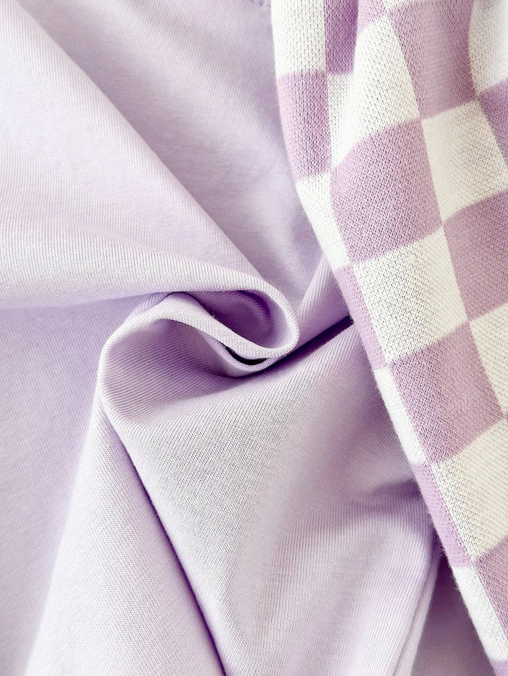 Close-up of lilac fabric with a checkered pattern