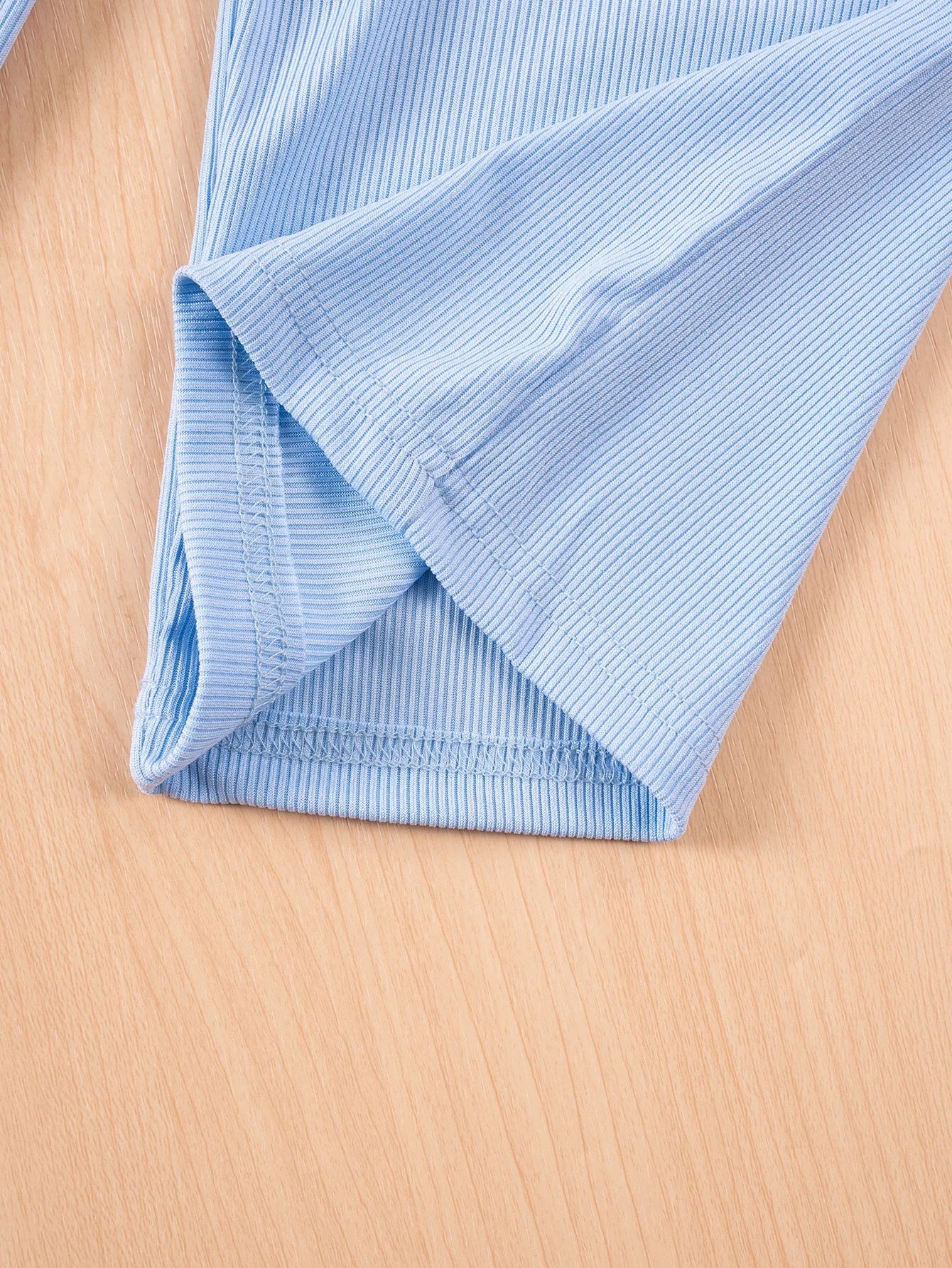 Folded blue fabric on a wooden surface