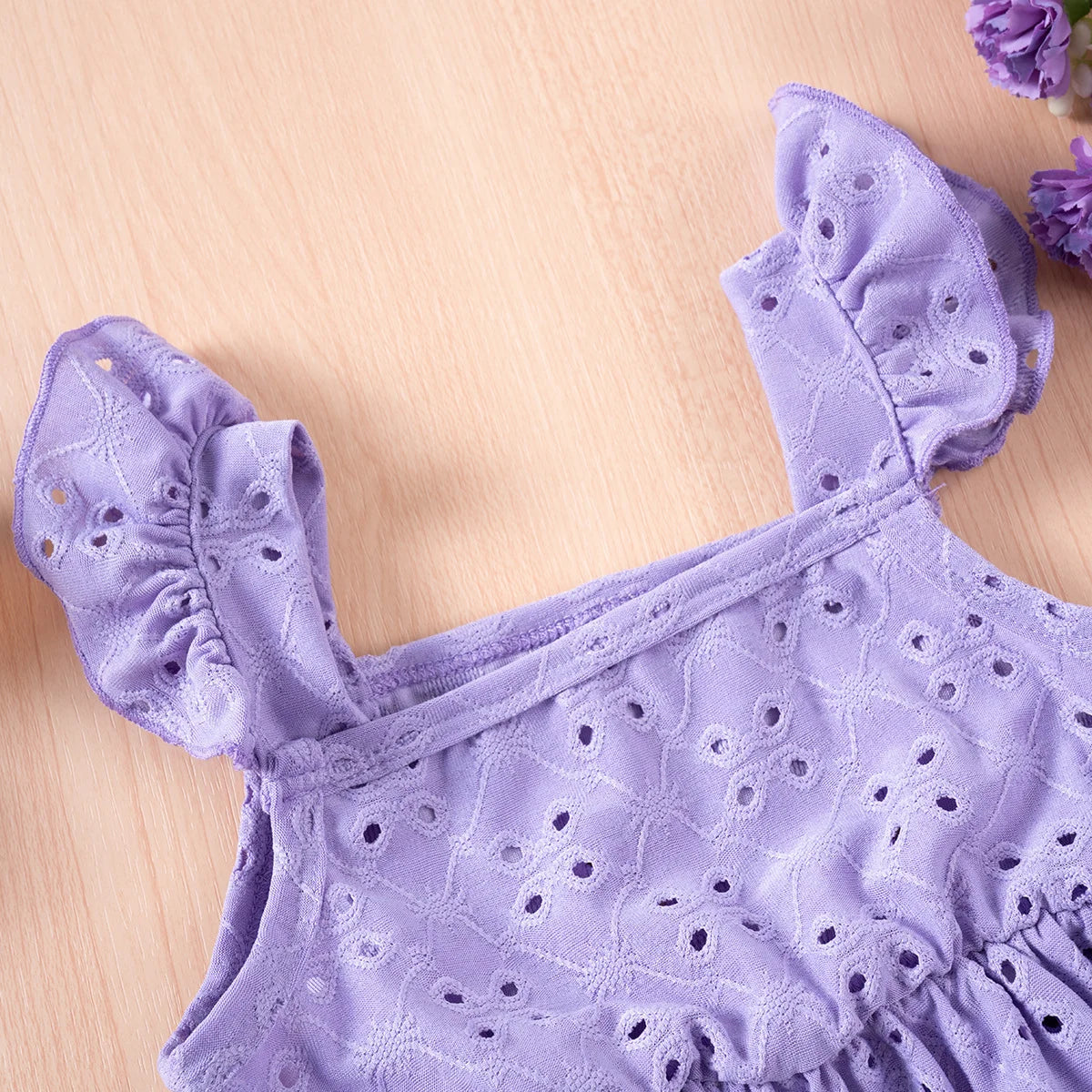 Purple dress with floral patterns on a wooden surface