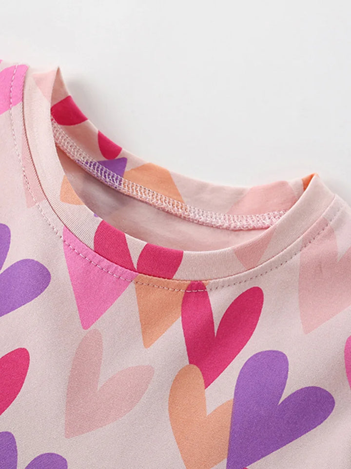 Close-up of a shirt with colorful heart pattern on a light background