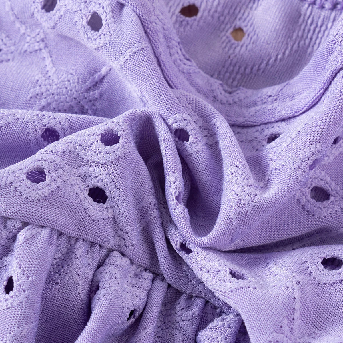 Close-up of purple fabric with a textured pattern
