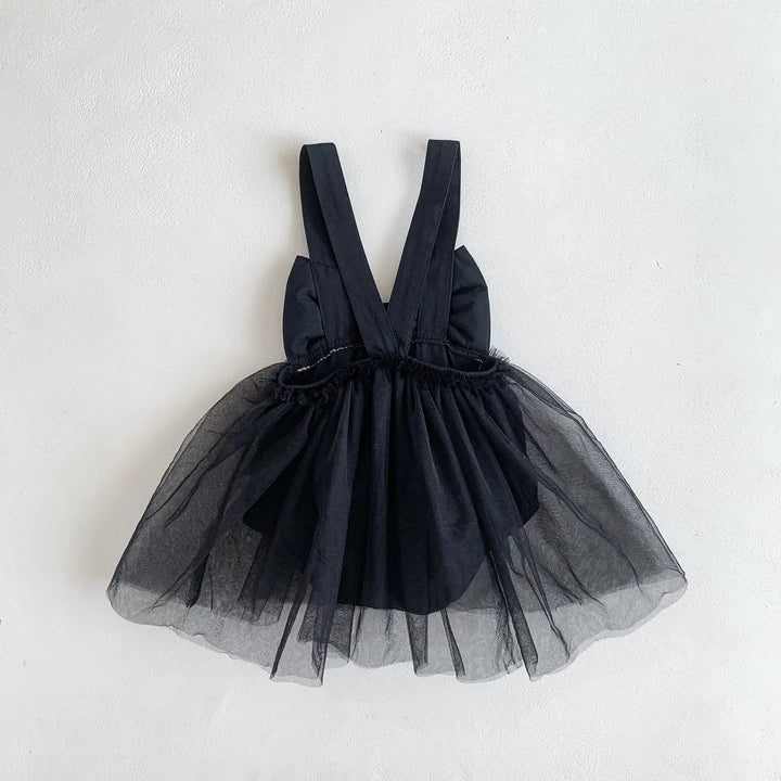 Black tulle dress with straps on a light gray background