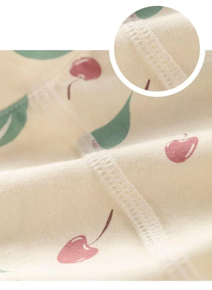 Close-up of fabric with cherry pattern and a magnified section showing texture.
