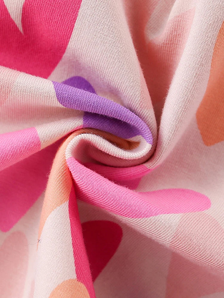 Close-up of colorful fabric with pink, purple, and orange patterns.
