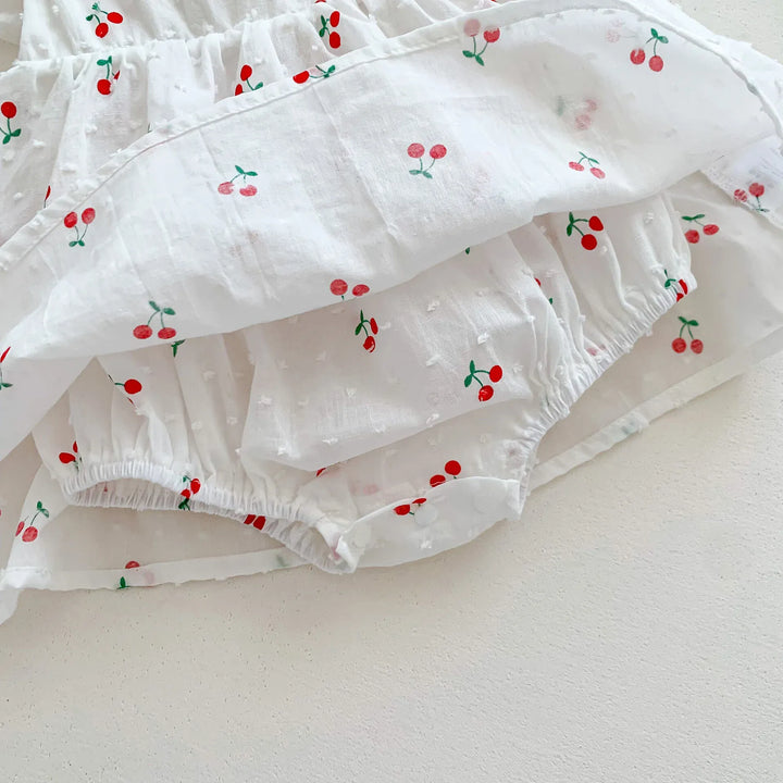 White ruffled fabric with cherry pattern on a light background