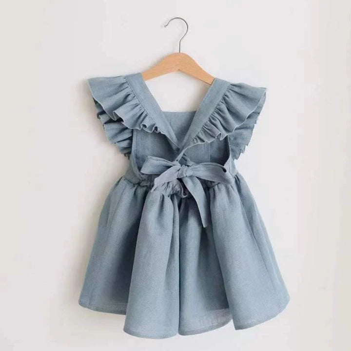 Blue dress with ruffled details on a wooden hanger against a white background