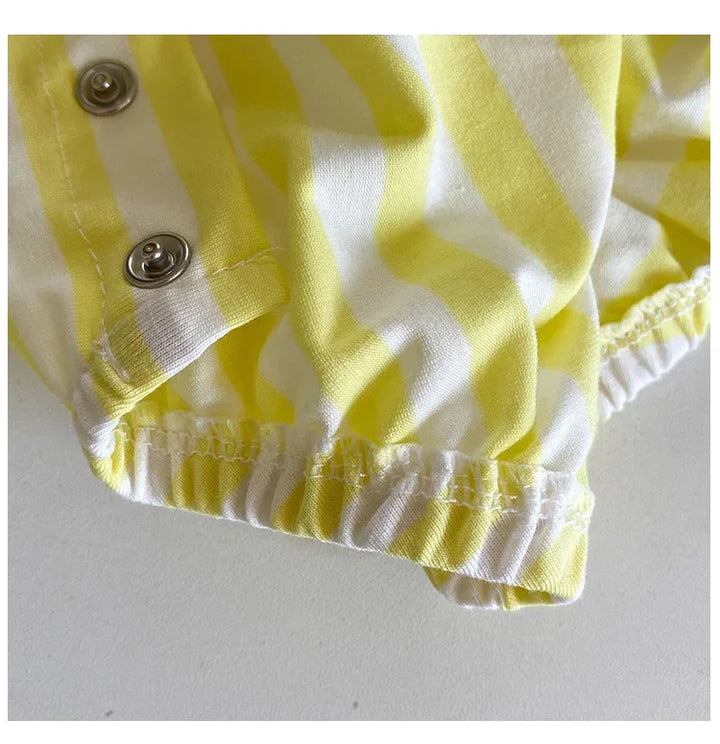 Yellow and white striped fabric with buttons on a light gray background