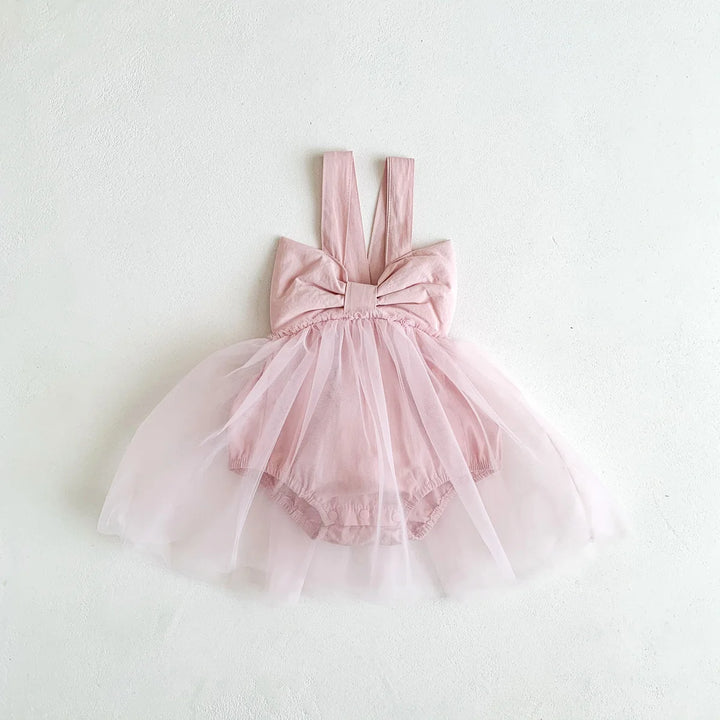 Pink dress with a large bow on a white background