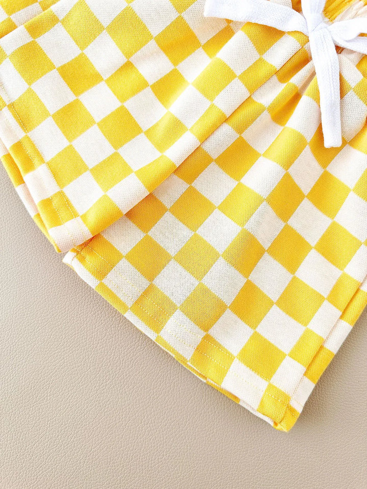 Yellow and white checkered fabric with a white ribbon on a beige background