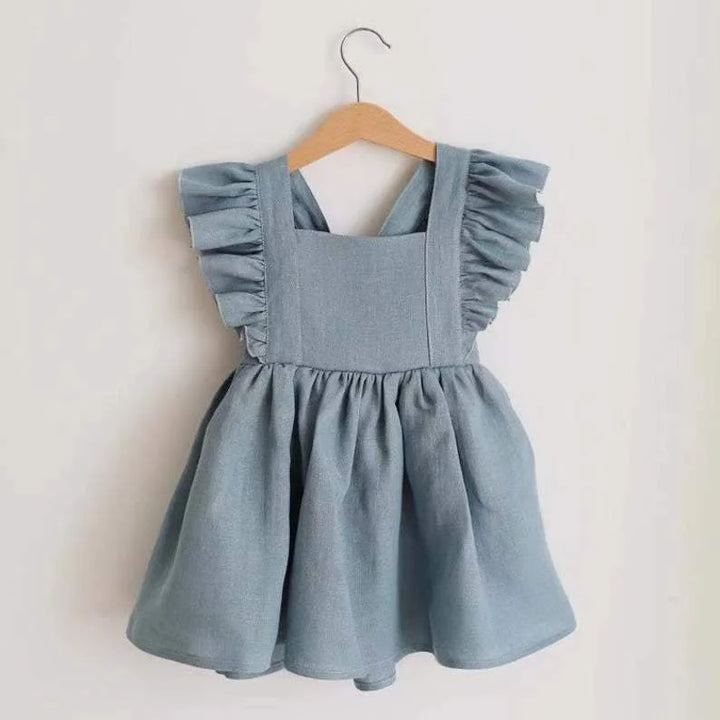 Light blue dress with ruffled straps on a wooden hanger against a white background
