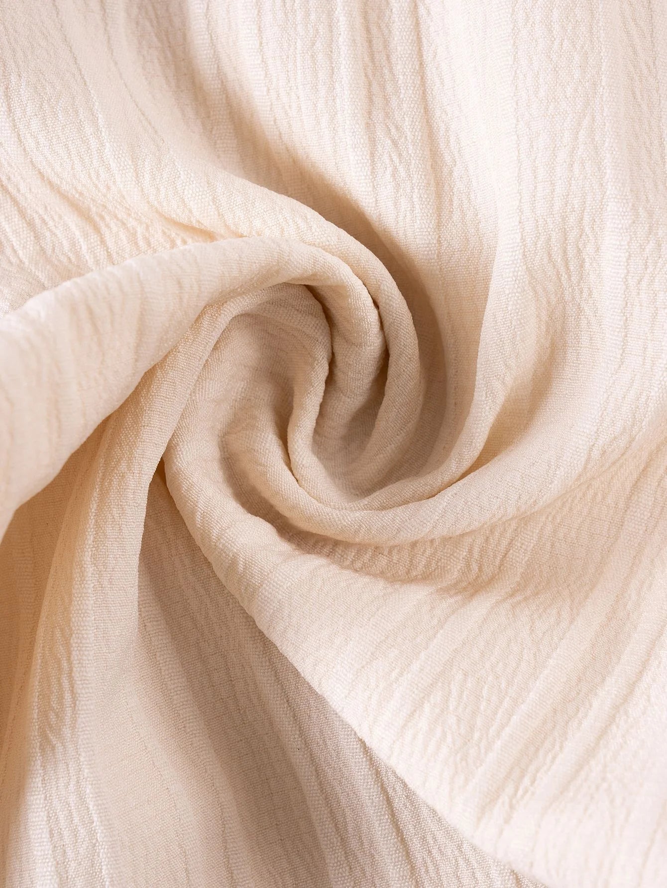 Close-up of beige fabric with folds