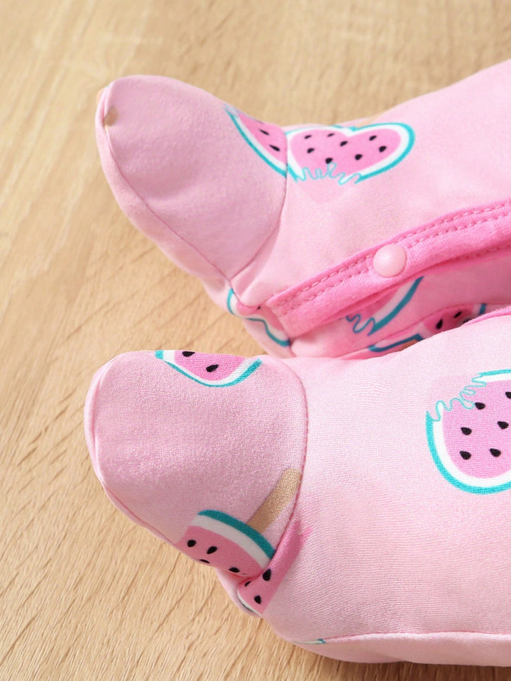 Pink children's shoes with watermelon pattern on a wooden floor