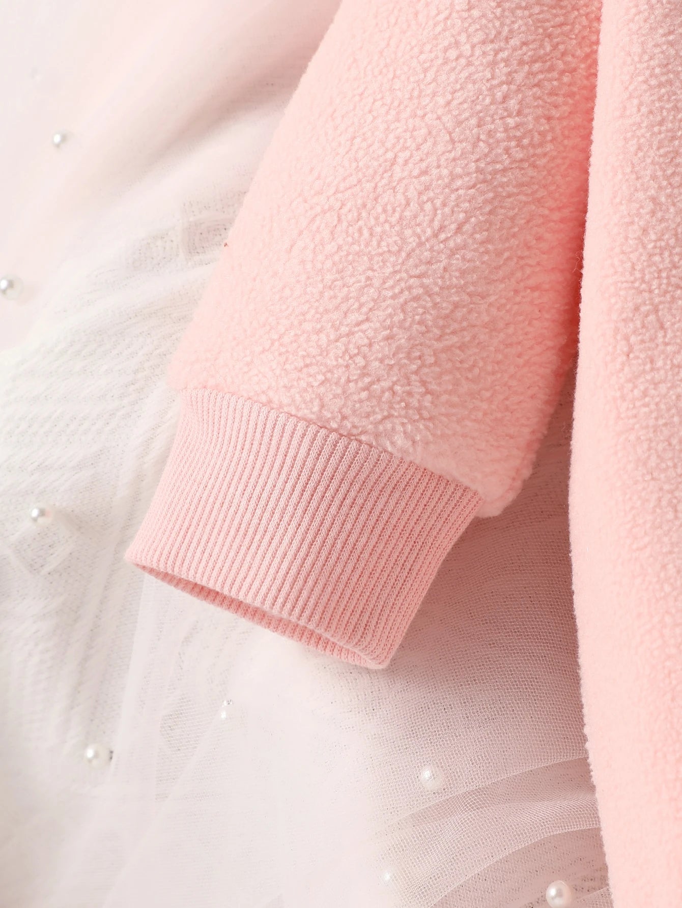 Close-up of a pink textured garment with a blurred background
