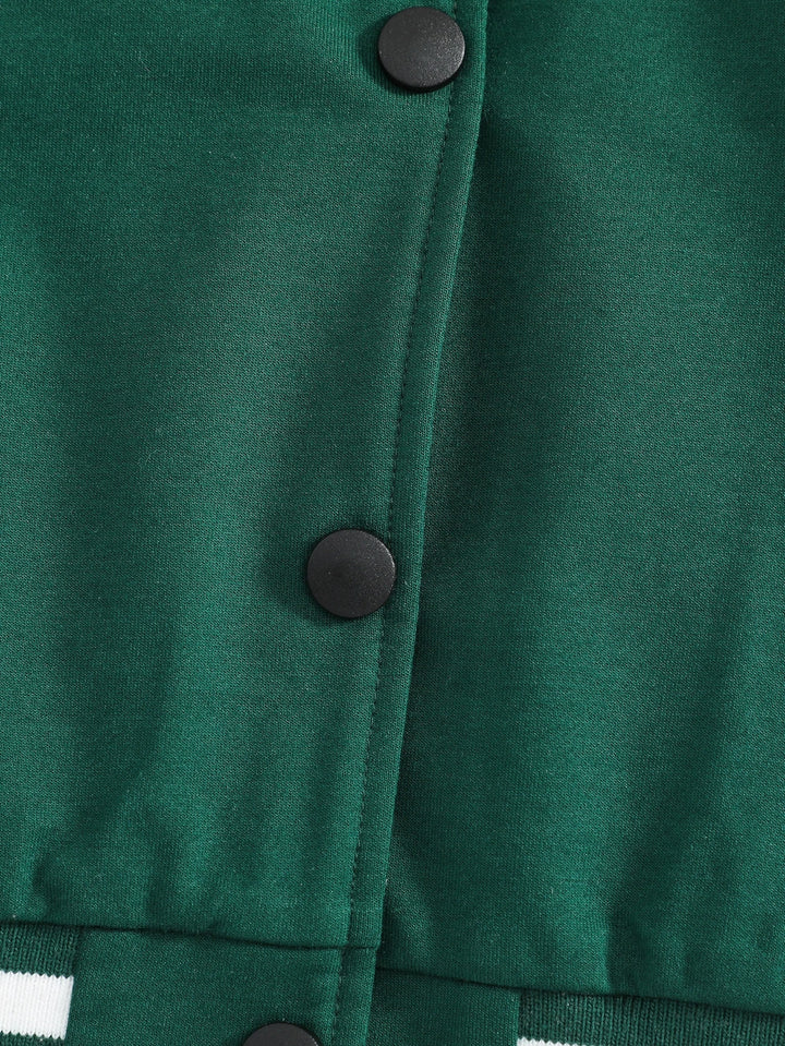 Close-up of a green jacket with buttons on a plain background
