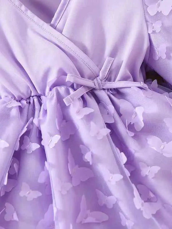 Close-up of a lavender dress with butterfly patterns