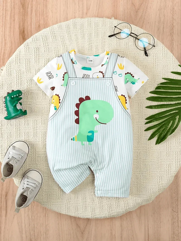 Children's outfit with dinosaur-themed overalls and shirt on a round beige mat.