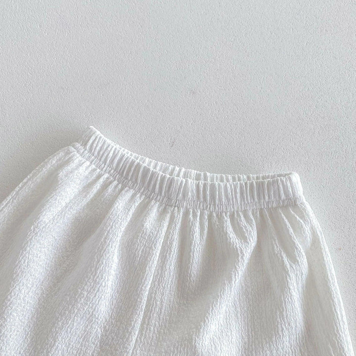 White textured fabric on a light gray background