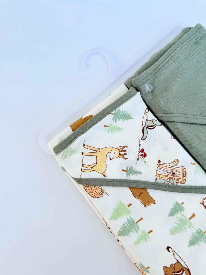 Baby blanket with animal and nature pattern on a light blue background