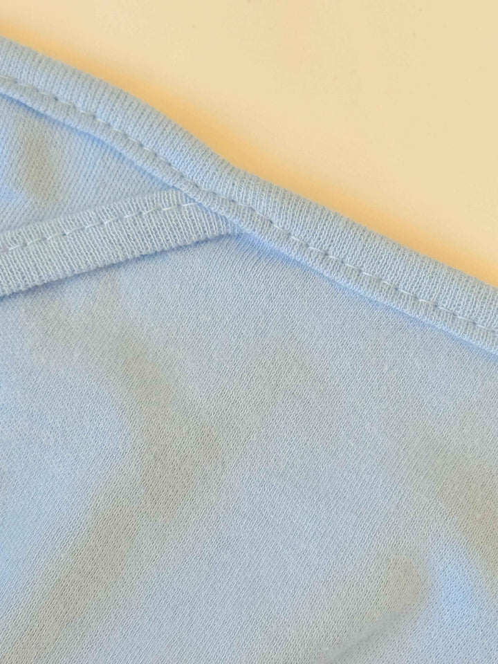 Close-up of light blue fabric with a yellow background