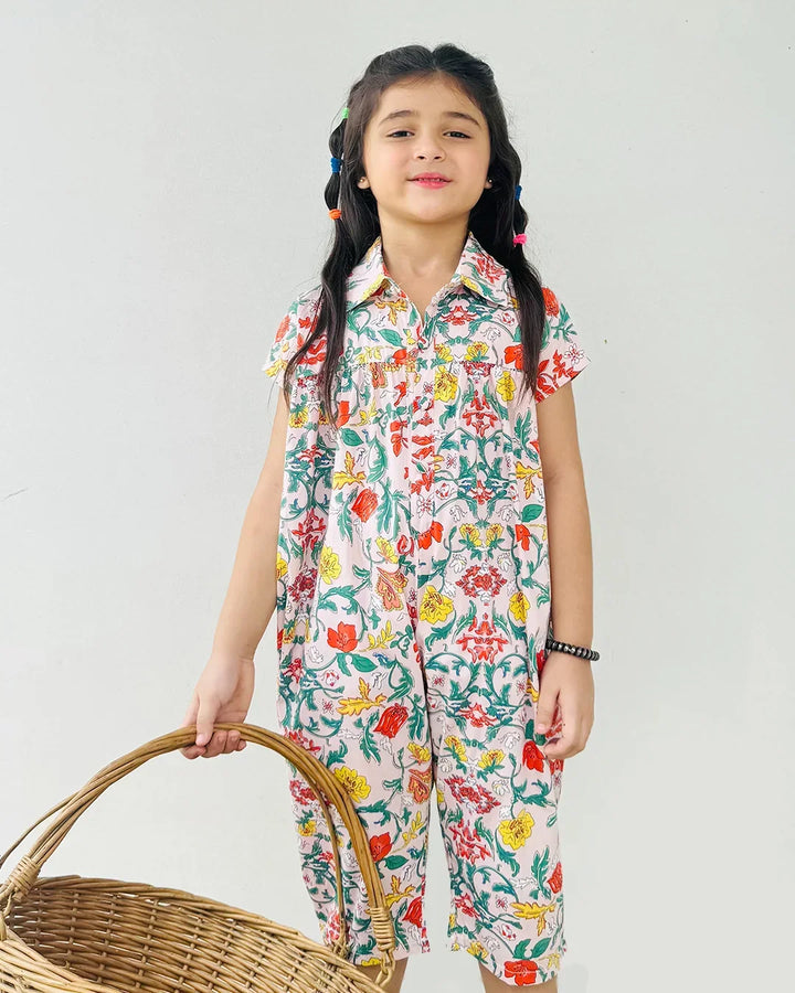 Young girl wearing a colorful floral dress holding a woven basket against a white background