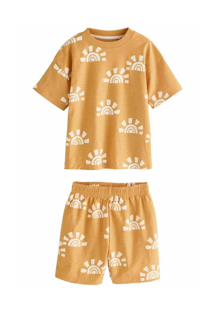 Children's yellow outfit with sun pattern on a white background