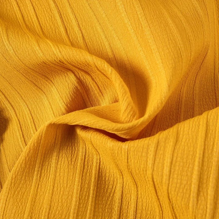 Close-up of yellow fabric with visible texture