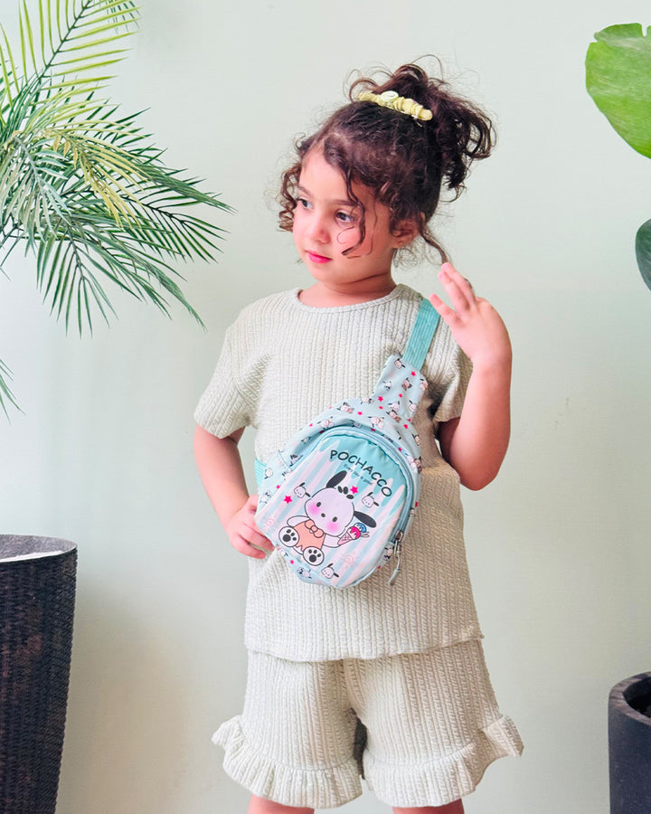 Child wearing a small backpack with cartoon design against a light background
