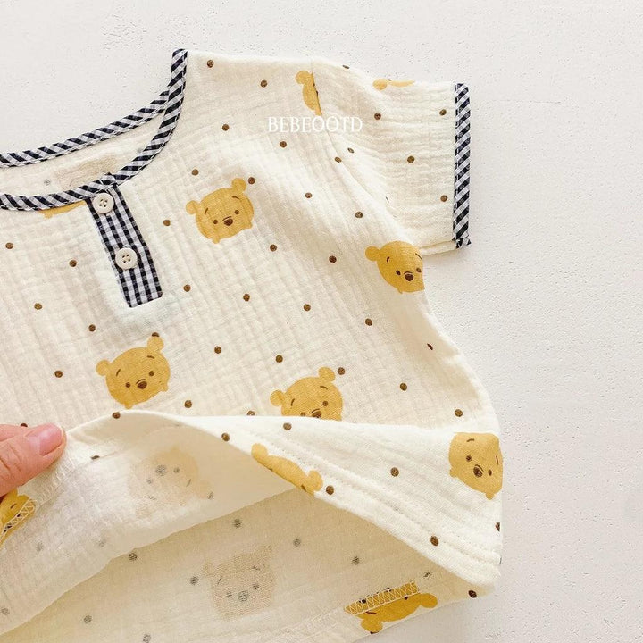 Baby outfit with bear pattern on a white background