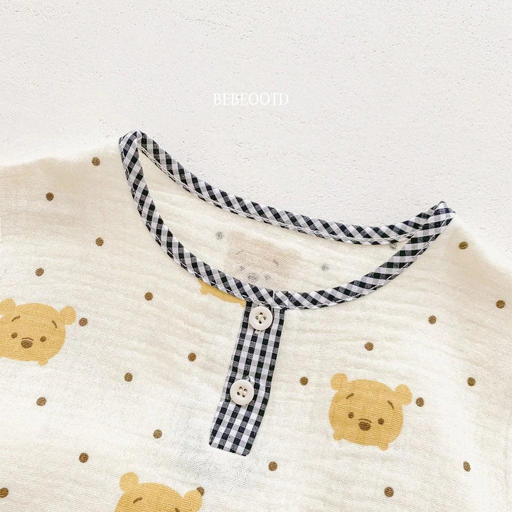 Children's clothing with bear faces and a checkered collar on a white background